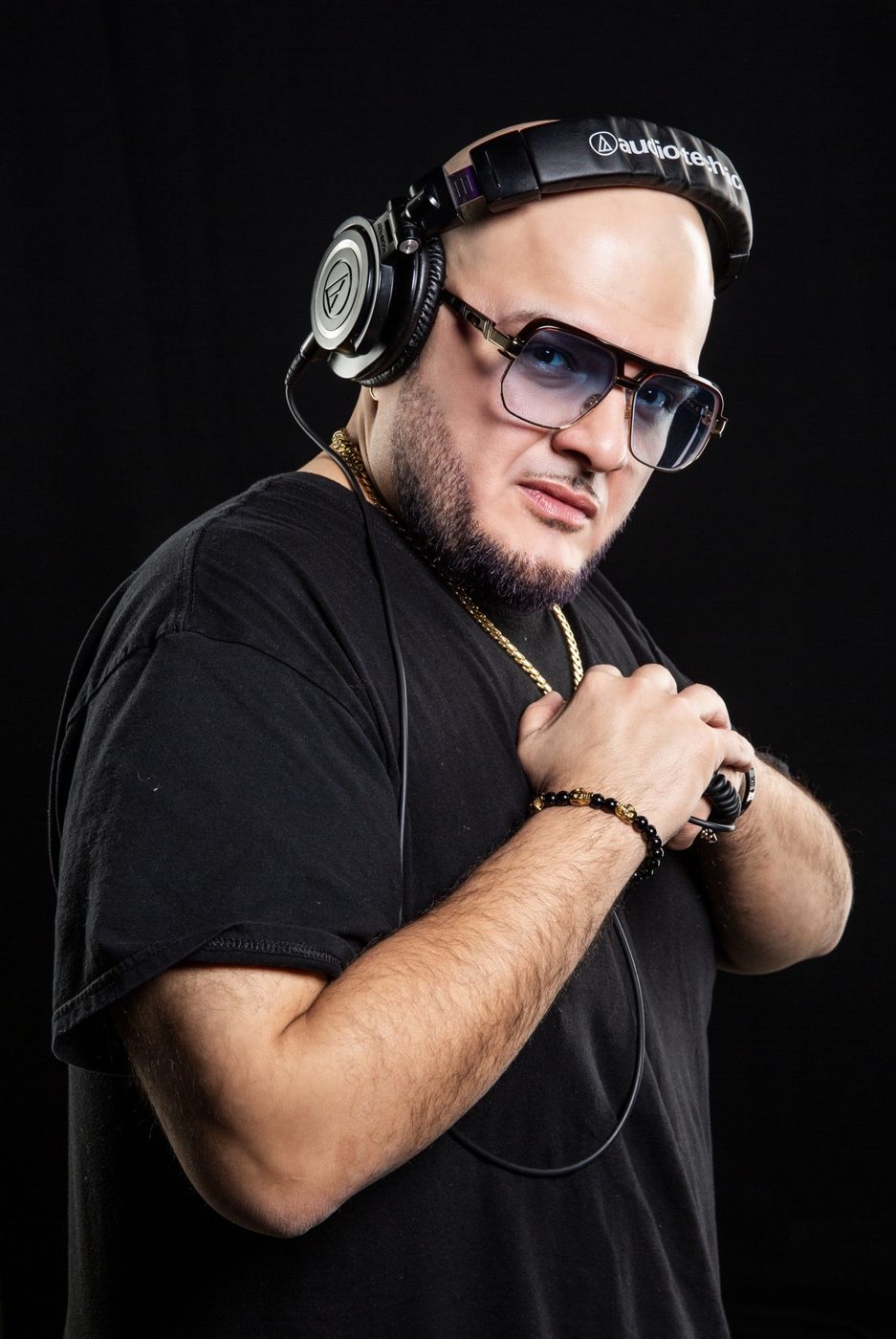 Portrait of a man in headphones and tinted glasses