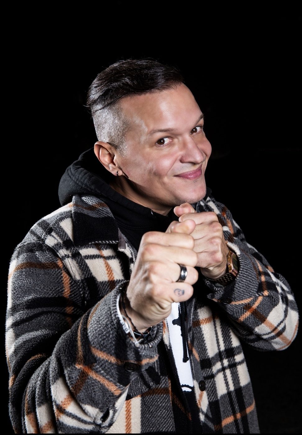 Playful portrait of a man in a plaid jacket